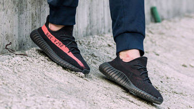 yeezy black red on feet