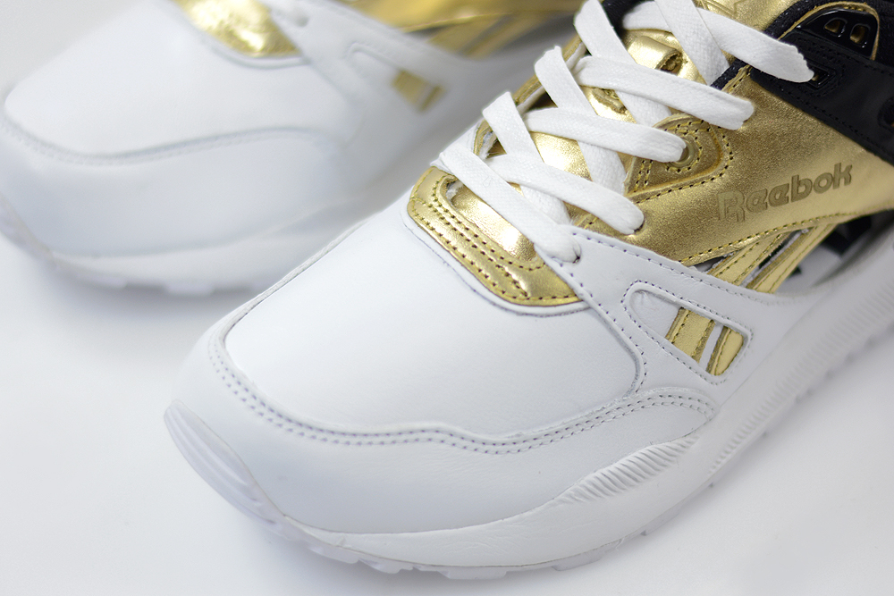 gold and white reebok