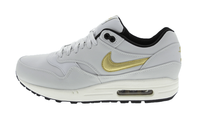 white nike trainers gold tick