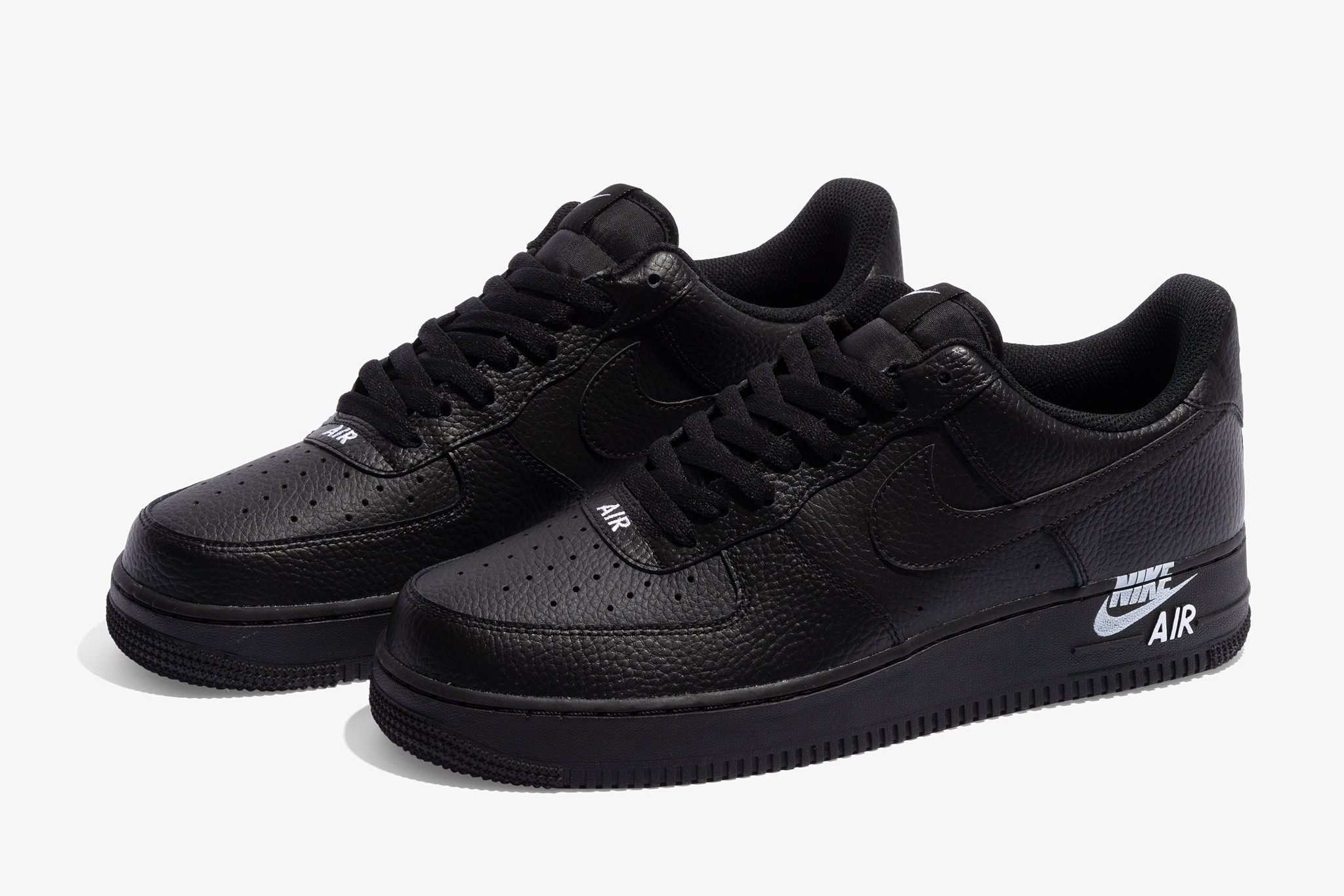 The Nike Air Force 1 Stamp Logo Follows With A Triple Black