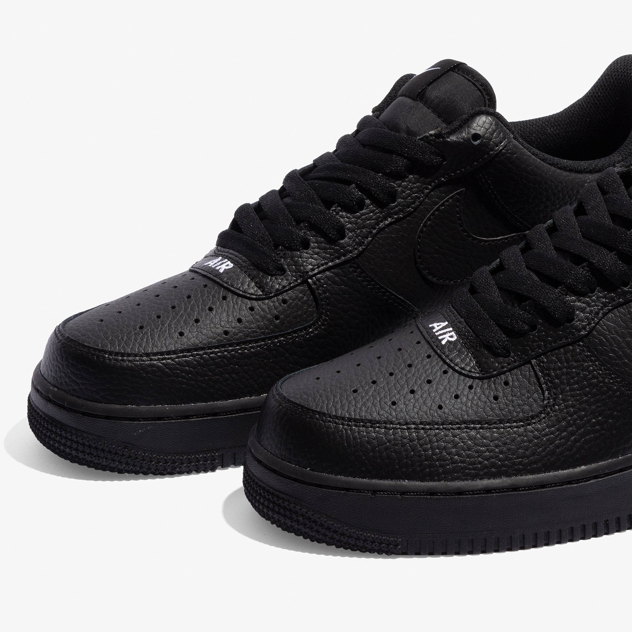 The Nike Air Force 1 Stamp Logo Follows With A Triple Black