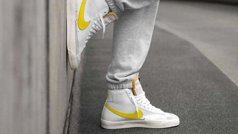 white and yellow nike blazers