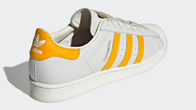 white adidas with gold back