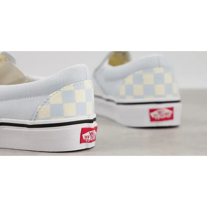 Light blue slip on vans store with checkerboard