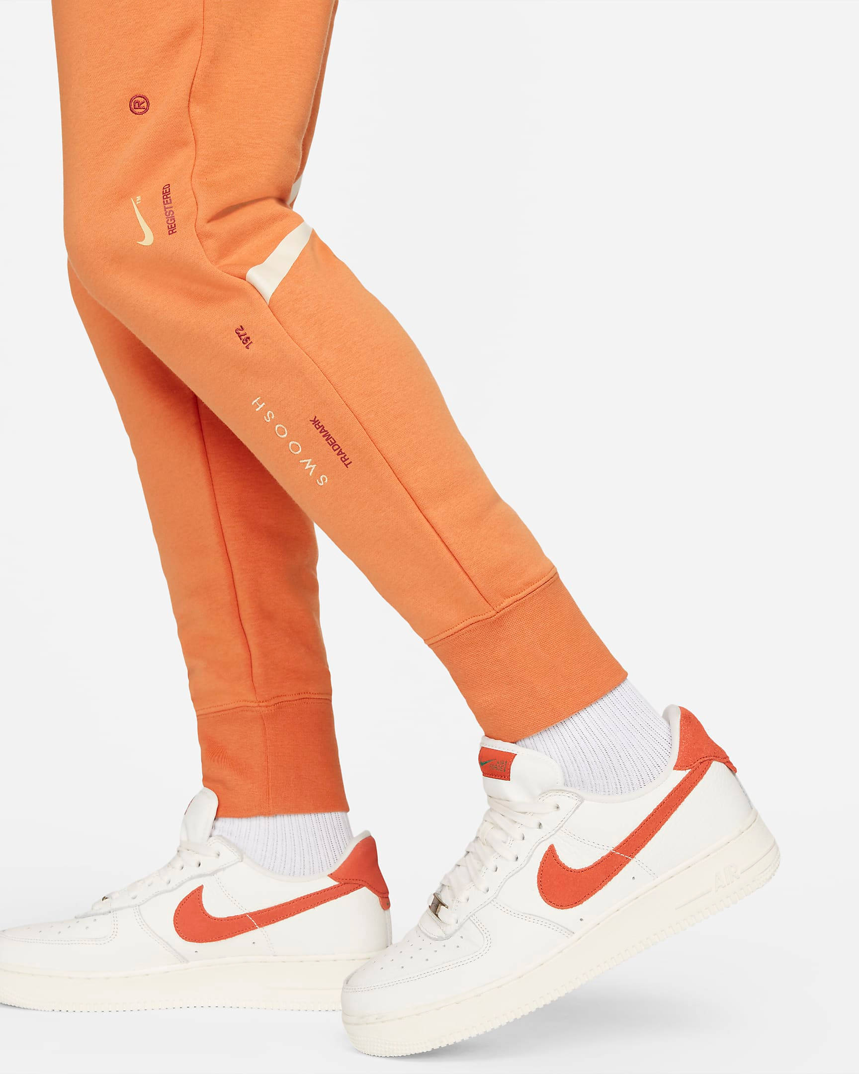 nike women's sportswear neon swoosh fleece pants orange