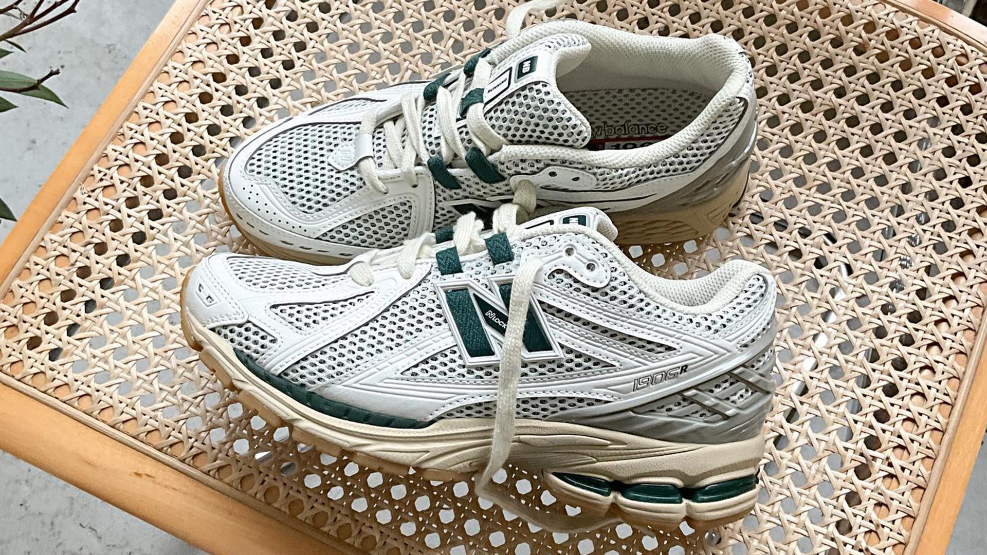 New Balance 1906R White Green on a chair