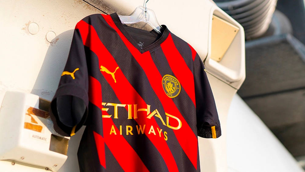 Image via PUMA Manchester City Debuts Its Red and Black 2022/23 Away Kit