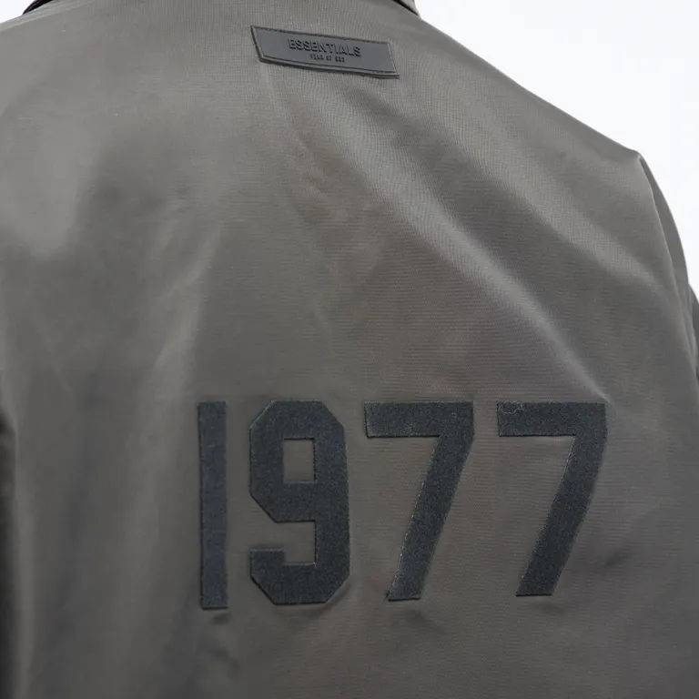 Fear of God Essentials 1977 Nylon Coaches Jacket Off Black Backside Closeup