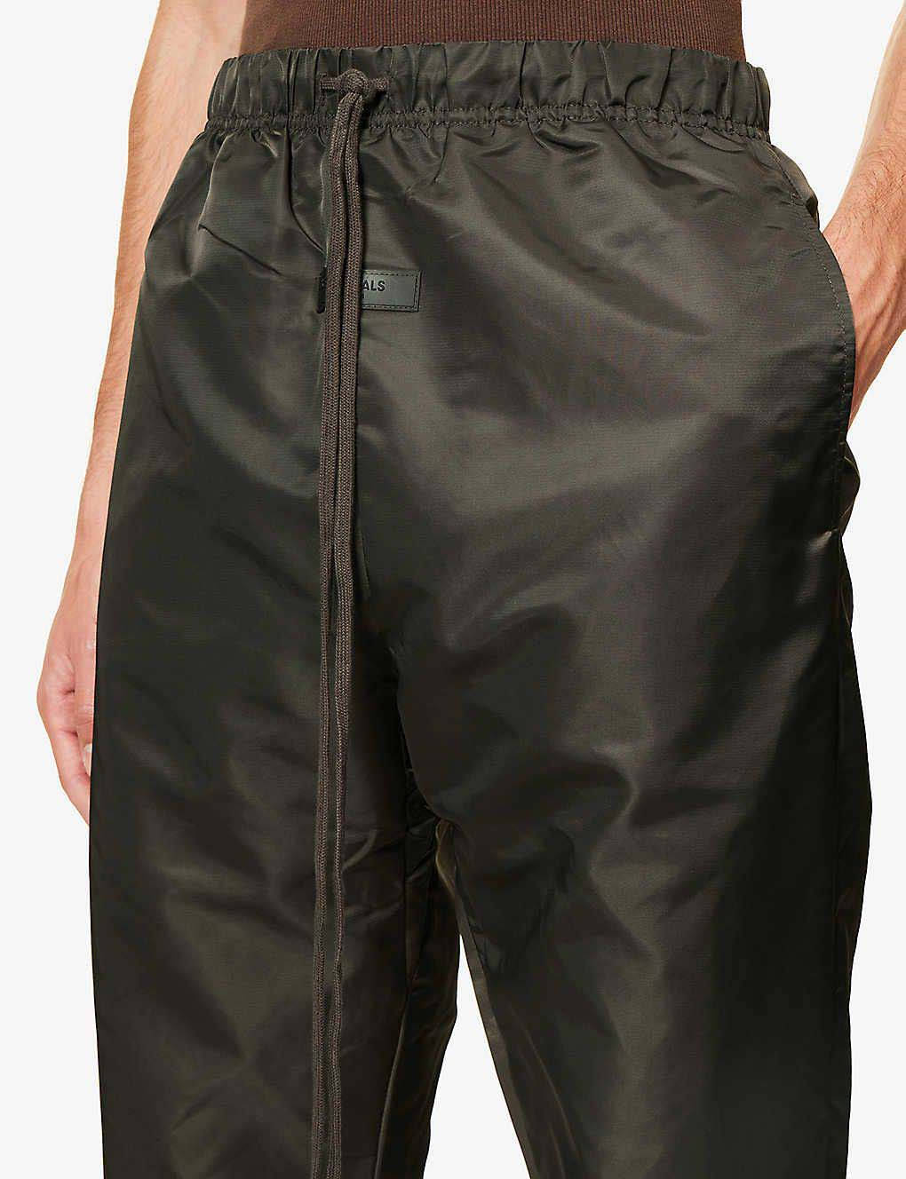 Fear of God ESSENTIALS Tapered Shell Jogging Bottoms Off Black Closeup 1