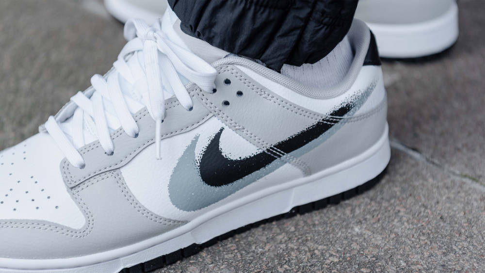 Image via The Sole Supplier Nike Dunk Low Stencil Swoosh Grey White