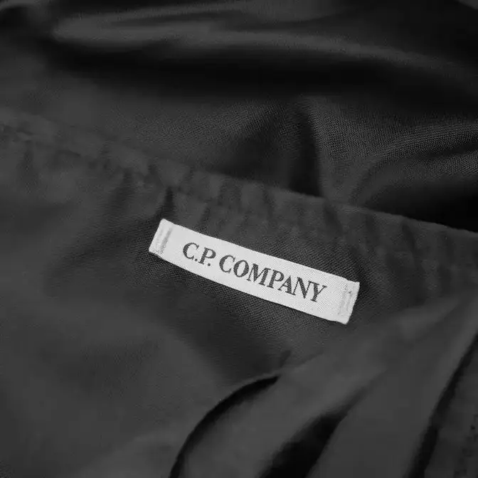 C.P. Company Lens Single Strap Cross Body Bag Black Logo Tag Closeup