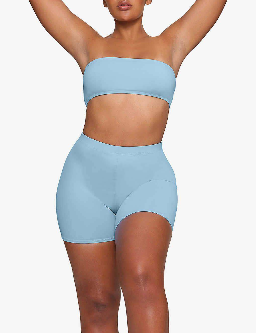 https://cms-cdn.thesolesupplier.co.uk/2023/06/skims-swim-recycled-stretch-nylon-swim-shorts-iris-blue-front.jpg