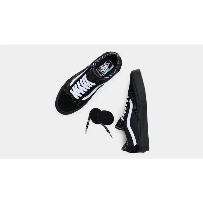 Vans all black on sale with white stripe