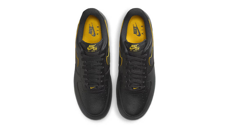 black nike with yellow swoosh