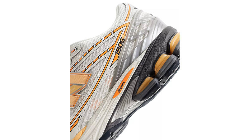 New Balance 1906 silver neon orange on foot heel