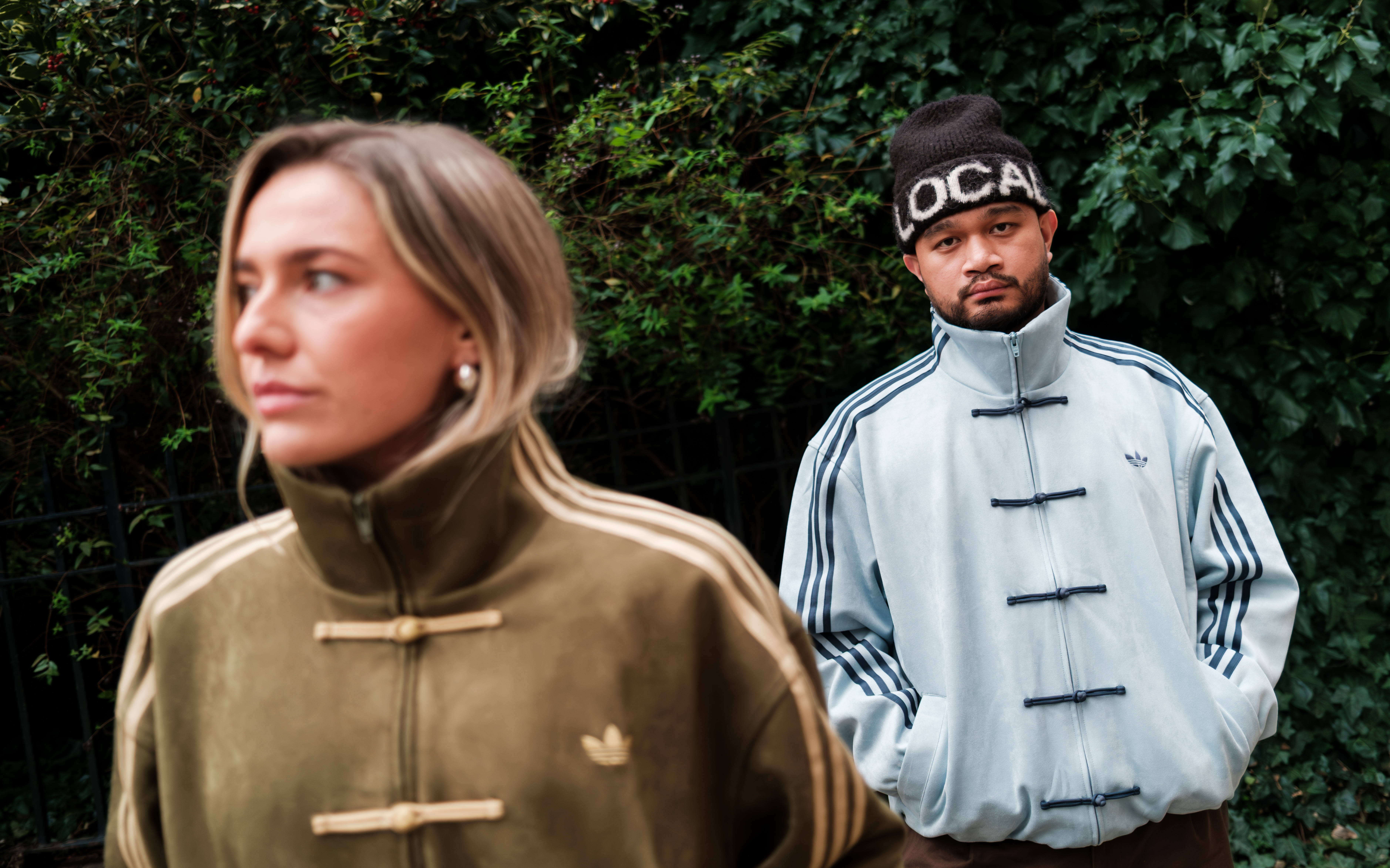 adidas Tang jacket green and blue colour styled against outdoor backdrop