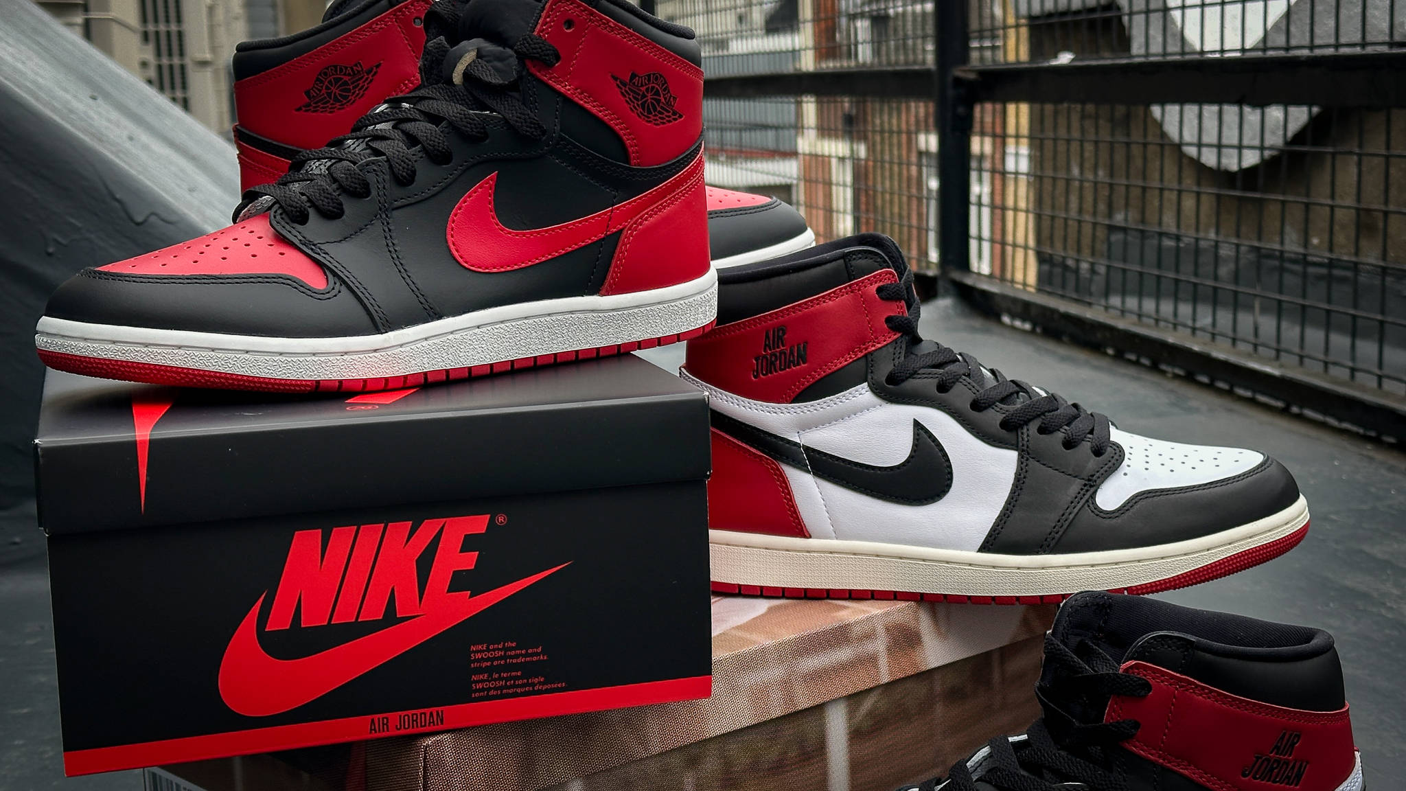 Air Jordan 1 Bred '85 stacked on top of Air Jordan 1 Reimagined Bred Toe along with both the sneakers special packaging