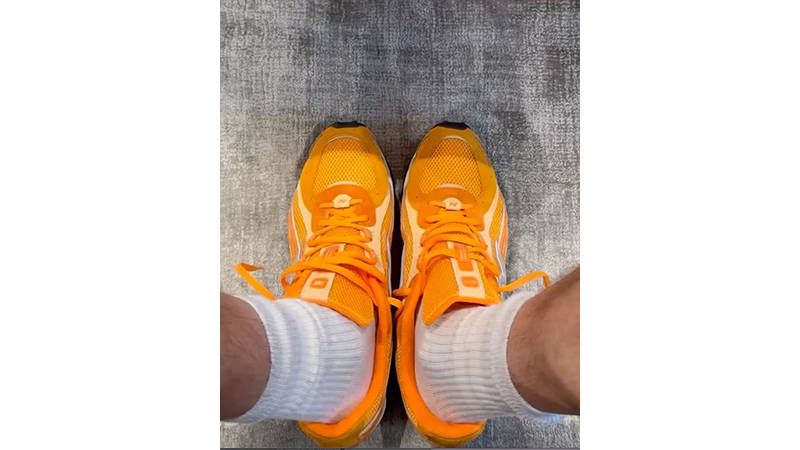 KITH x New Balance 204L Orange on foot