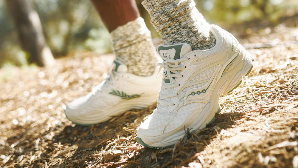 END. x Saucony ProGrid Omni 9 on foot with woodland background