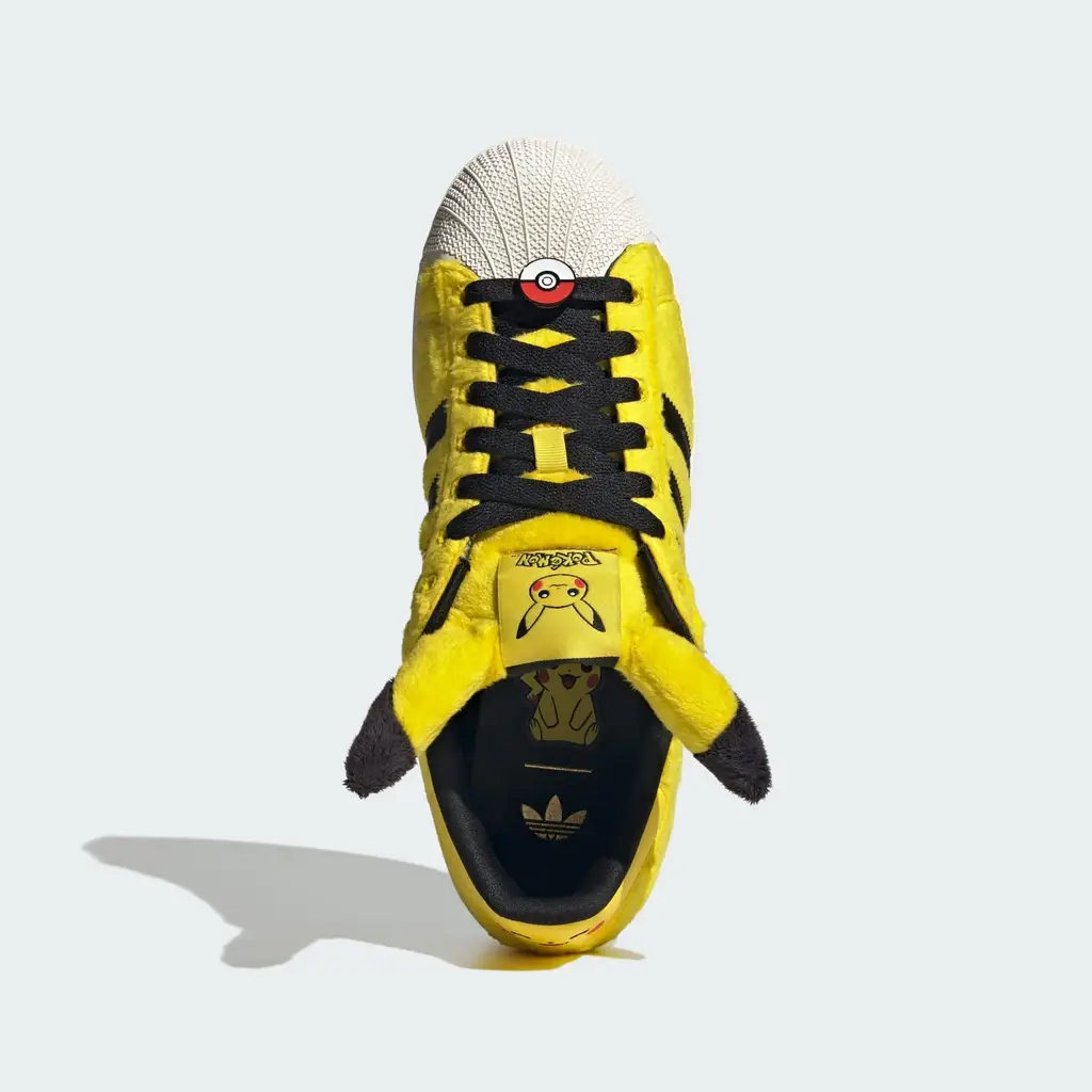 Pokemon x adidas Superstar Pikachu Yellow lateral view showing perforated 3-Stripes and gold-foil Superstar branding