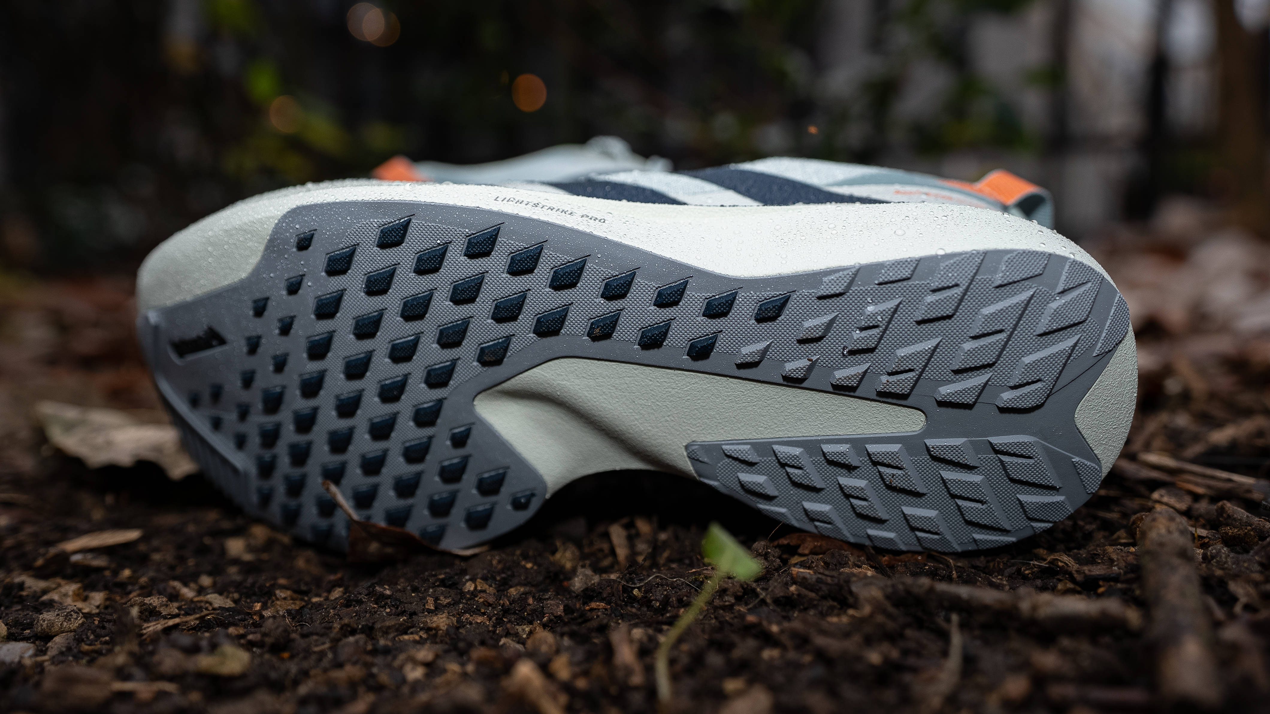 adidas adizero evo sl atr outsole with new 1.5mm lugs resting on woodland terrain