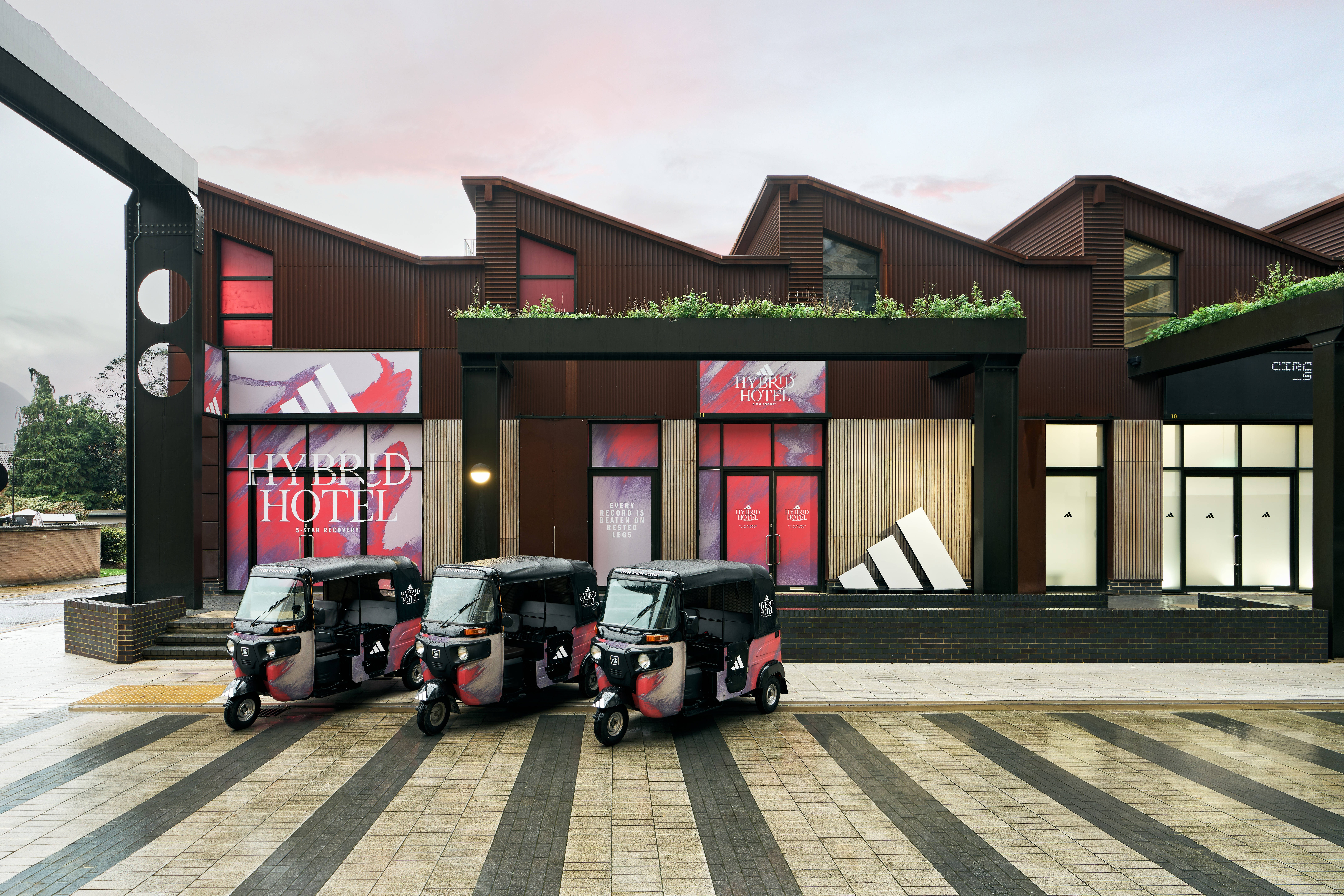 adidas hybrid hotel with tuktuk outside in east london