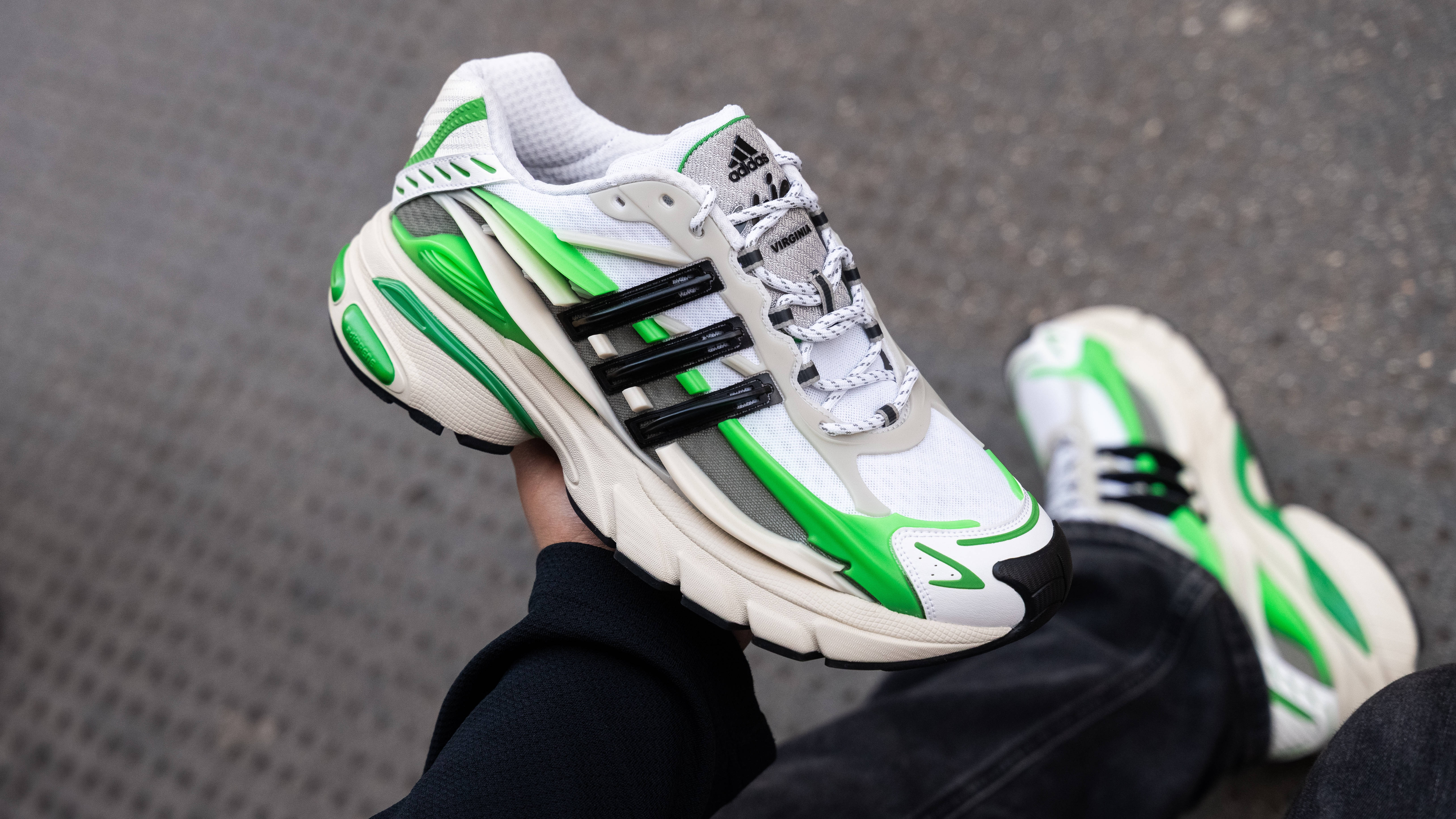 Pharrell x adidas Adistar Jellyfish Green White close up in hand shot with street backdrop