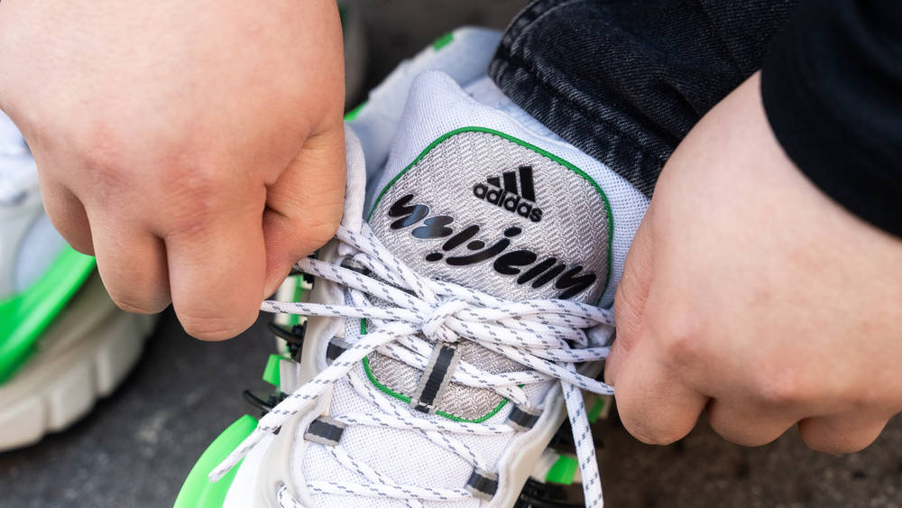 via The Sole Supplier Pharrell x adidas Adistar Jellyfish Green White close up of tongue tying up the duel coloured rope lace