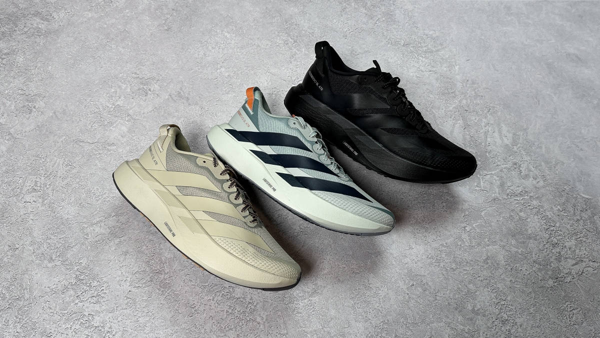 collection shot of the adidas EVO SL ATR in black blue and beige against a stone backdrop