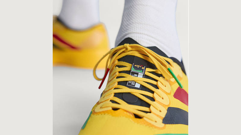 Bob Marley x adidas EVO SL Yellow Multi KJ3625 on foot tongue