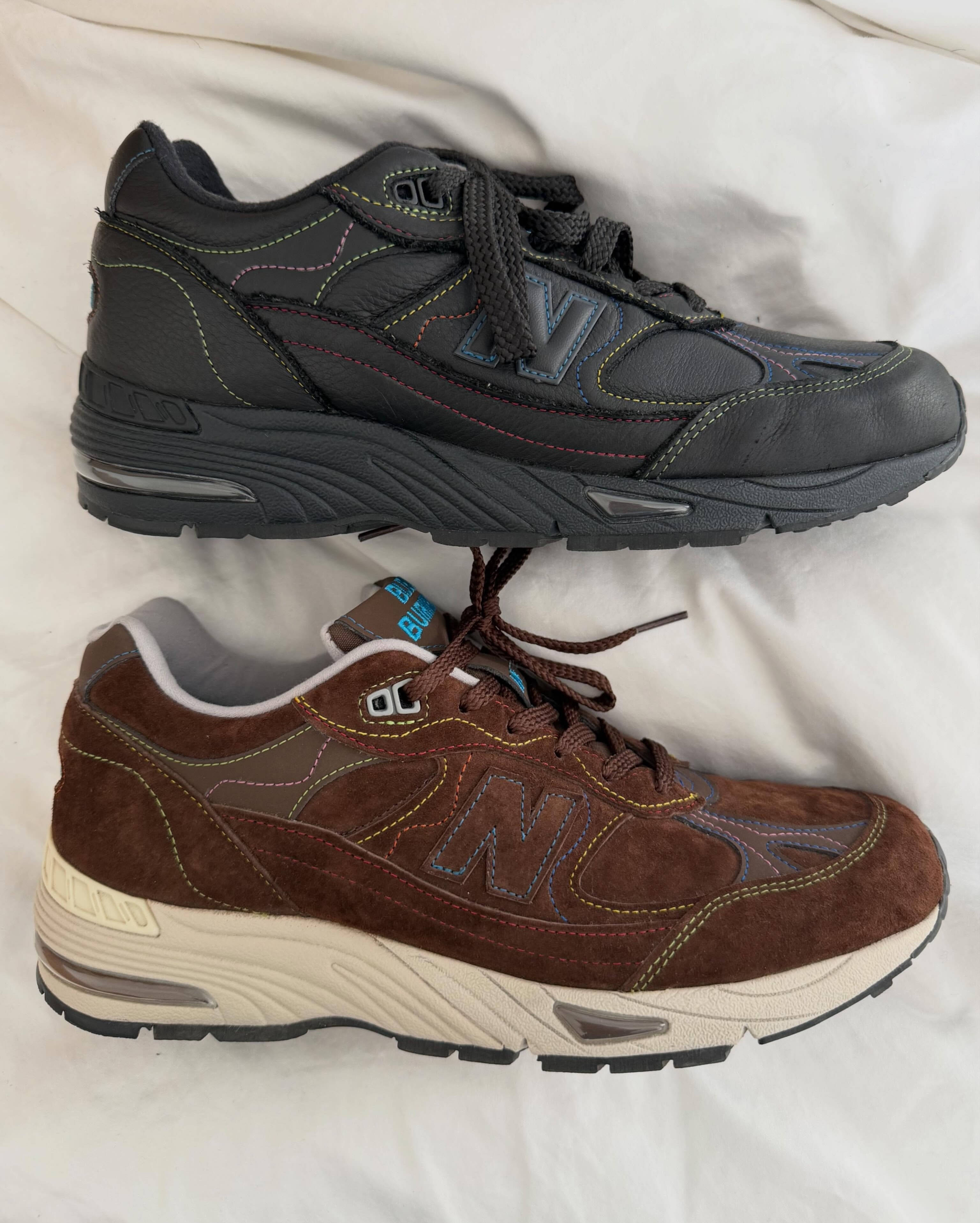 bleue burnham x new balance 991v1 brown and black colourway side profiles on a mattress