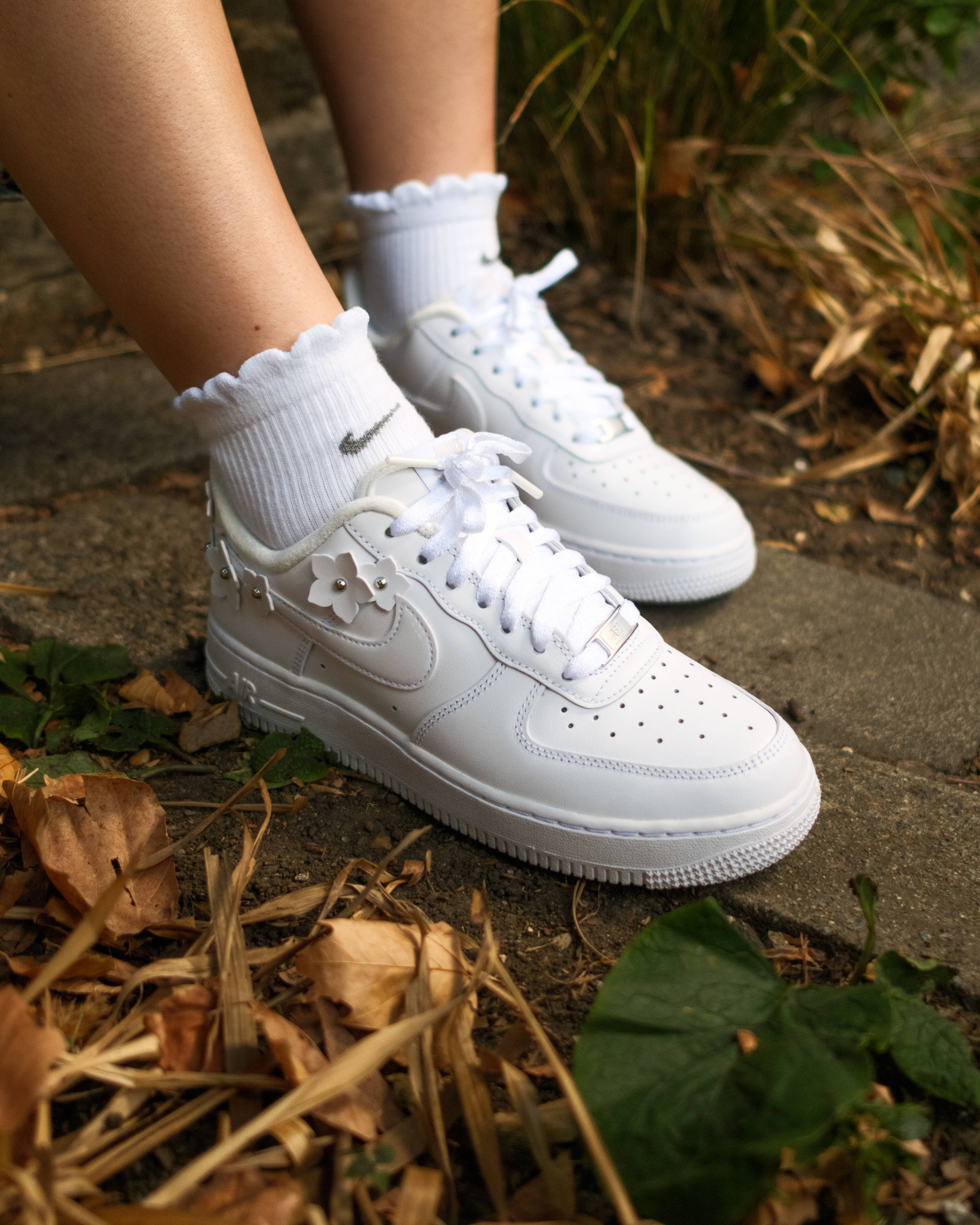 air force 1 femme floral detailing editorial style side profile leafy backdrop
