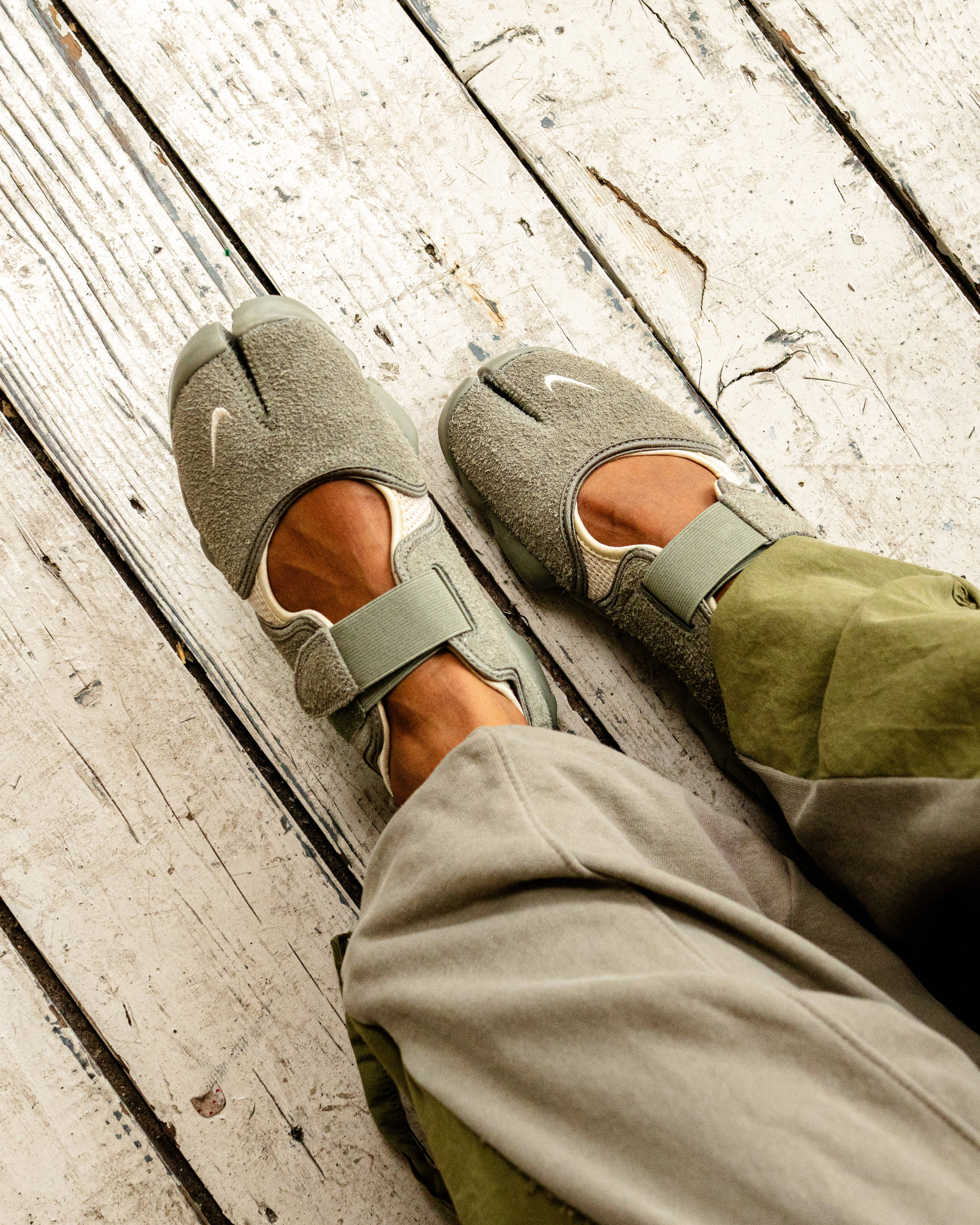 nike air rift on foot shot with rustic flooring backdrop