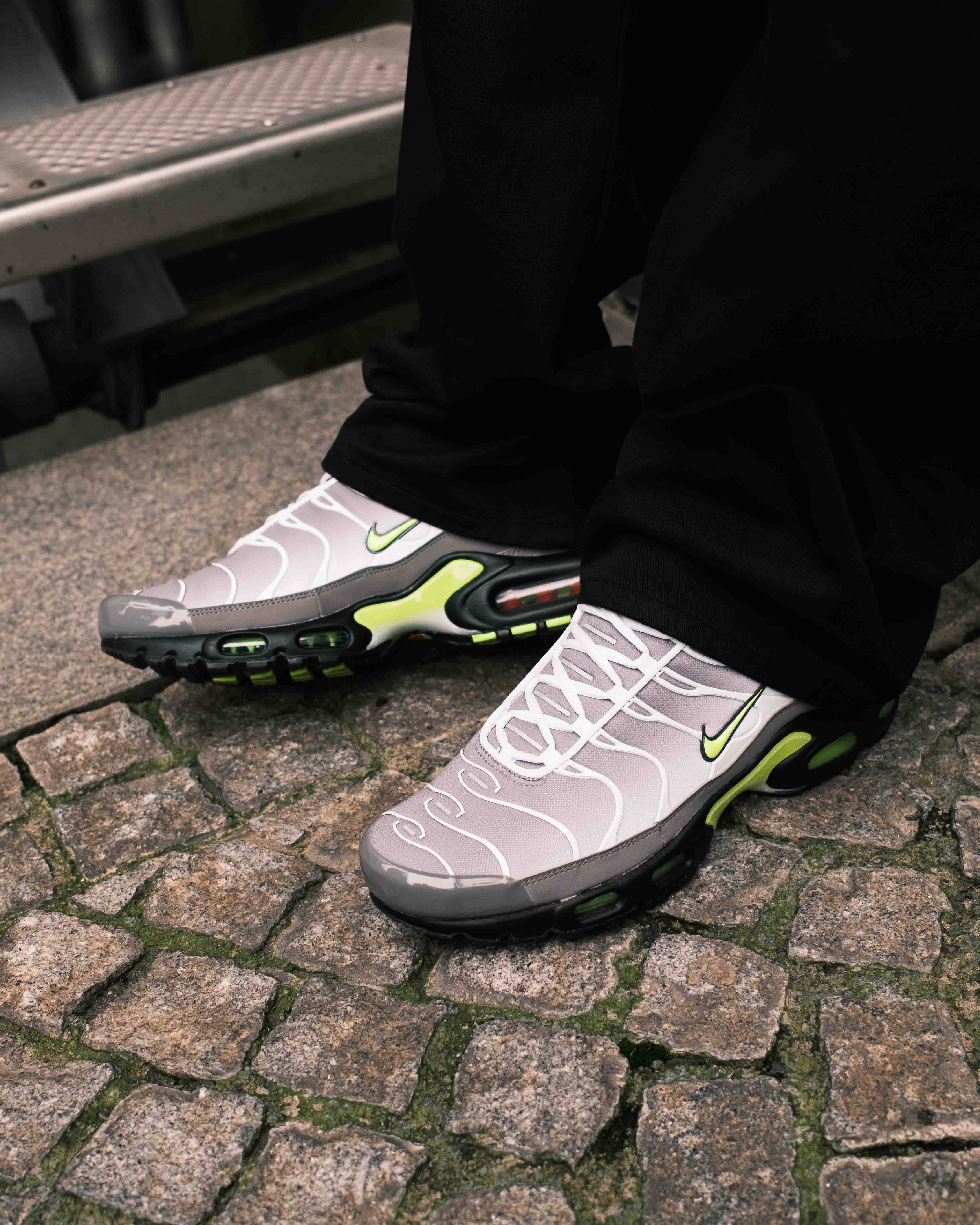 Nike Tn Neon up close shrouded by black track pant