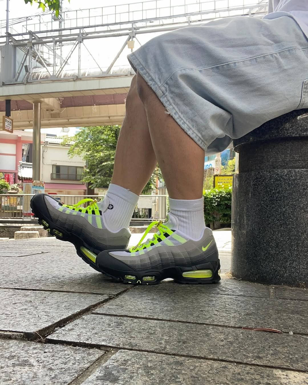 neon 110 styled with baggy denim shorts