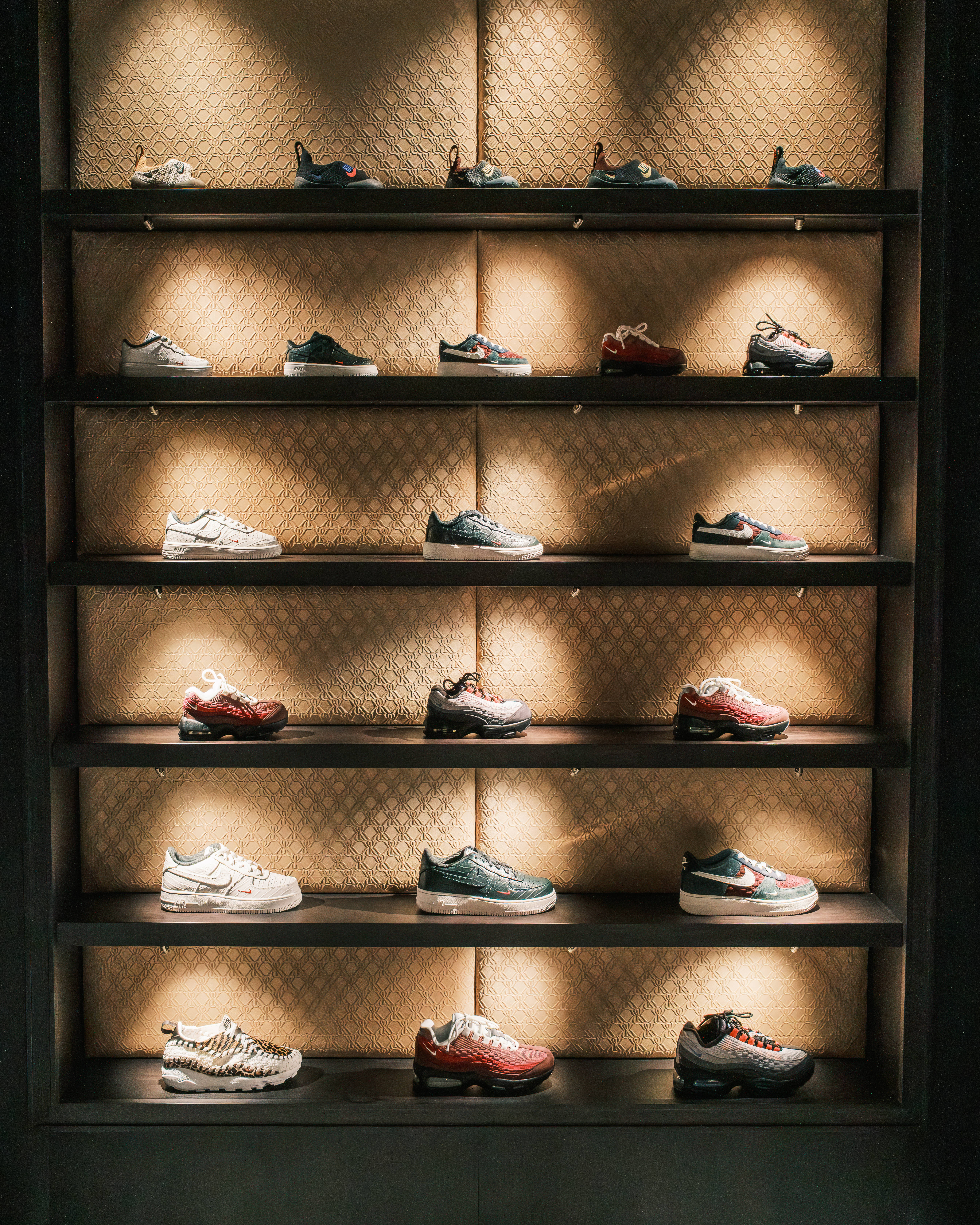 Sneaker wall dimly lit at the new Kith London location on Regent Street