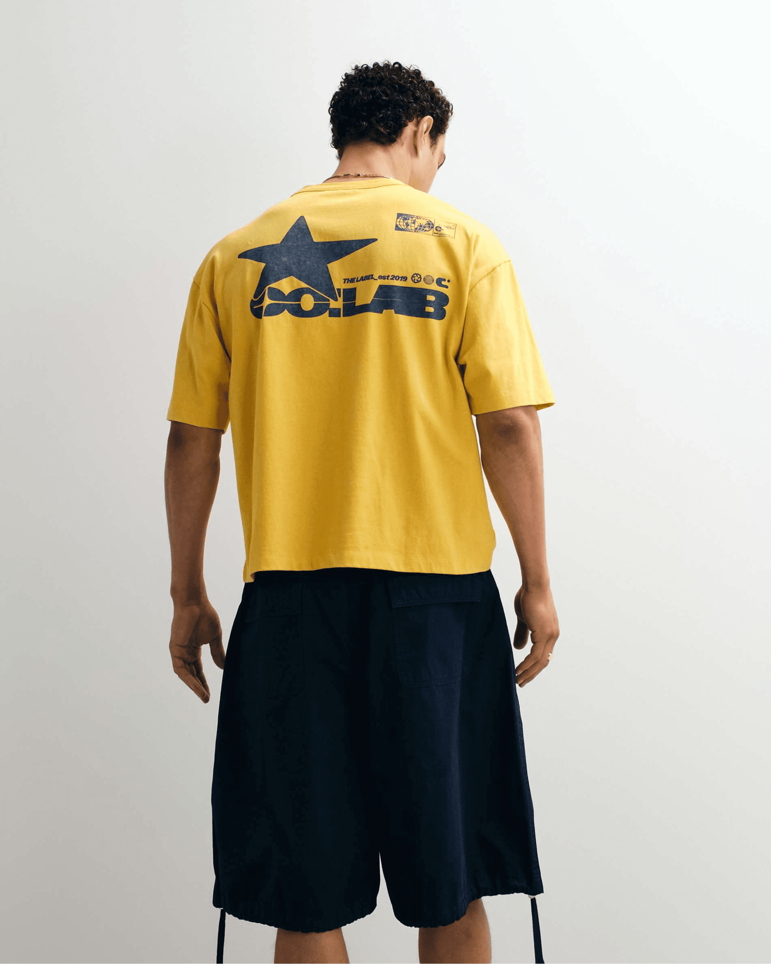 ASOS DESIGN oversized t-shirt with street graphic in yellow wash.