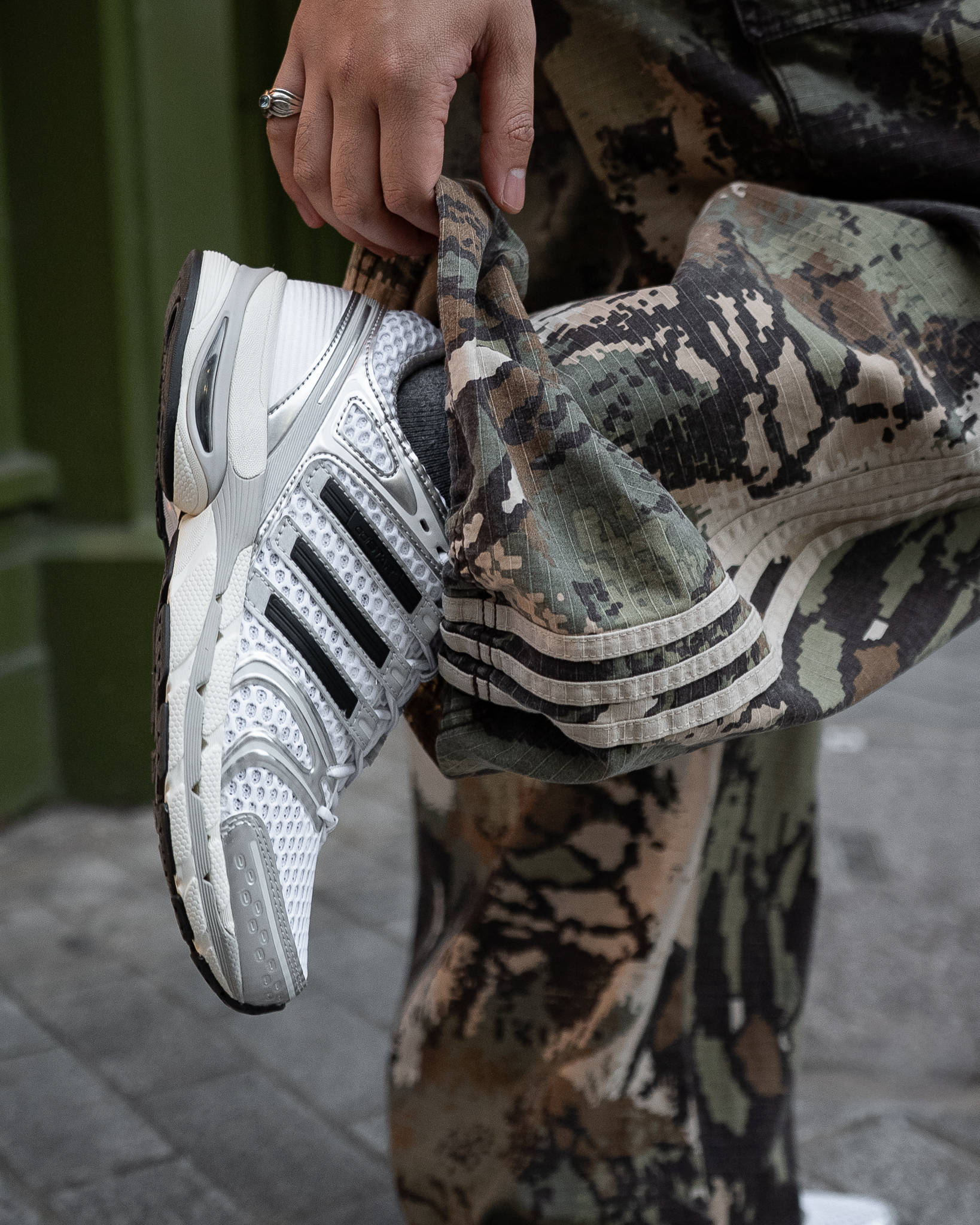 adidas Adistar Control 5 Silver Metallic up-close shot paired with adidas military camoflague pants