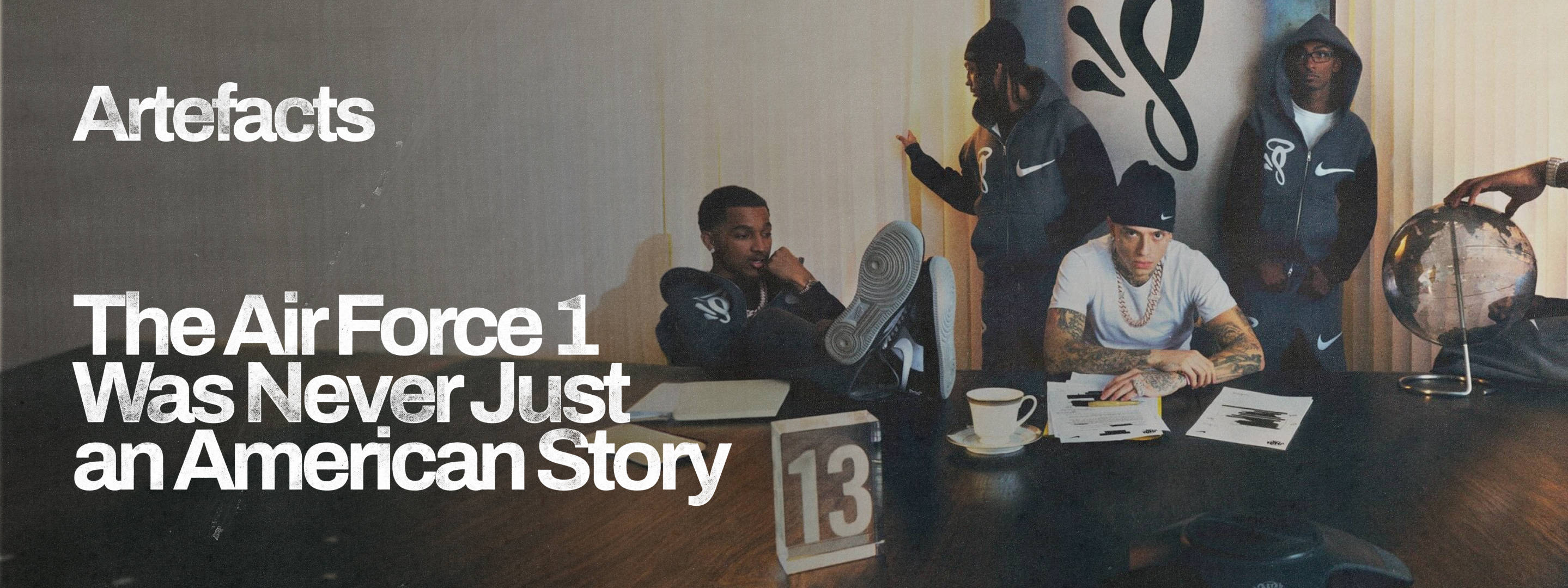 Central Cee uk rapper sat at boardroom table in his syna world x nike tracksuit with air force 1 kicked up onto table next to him