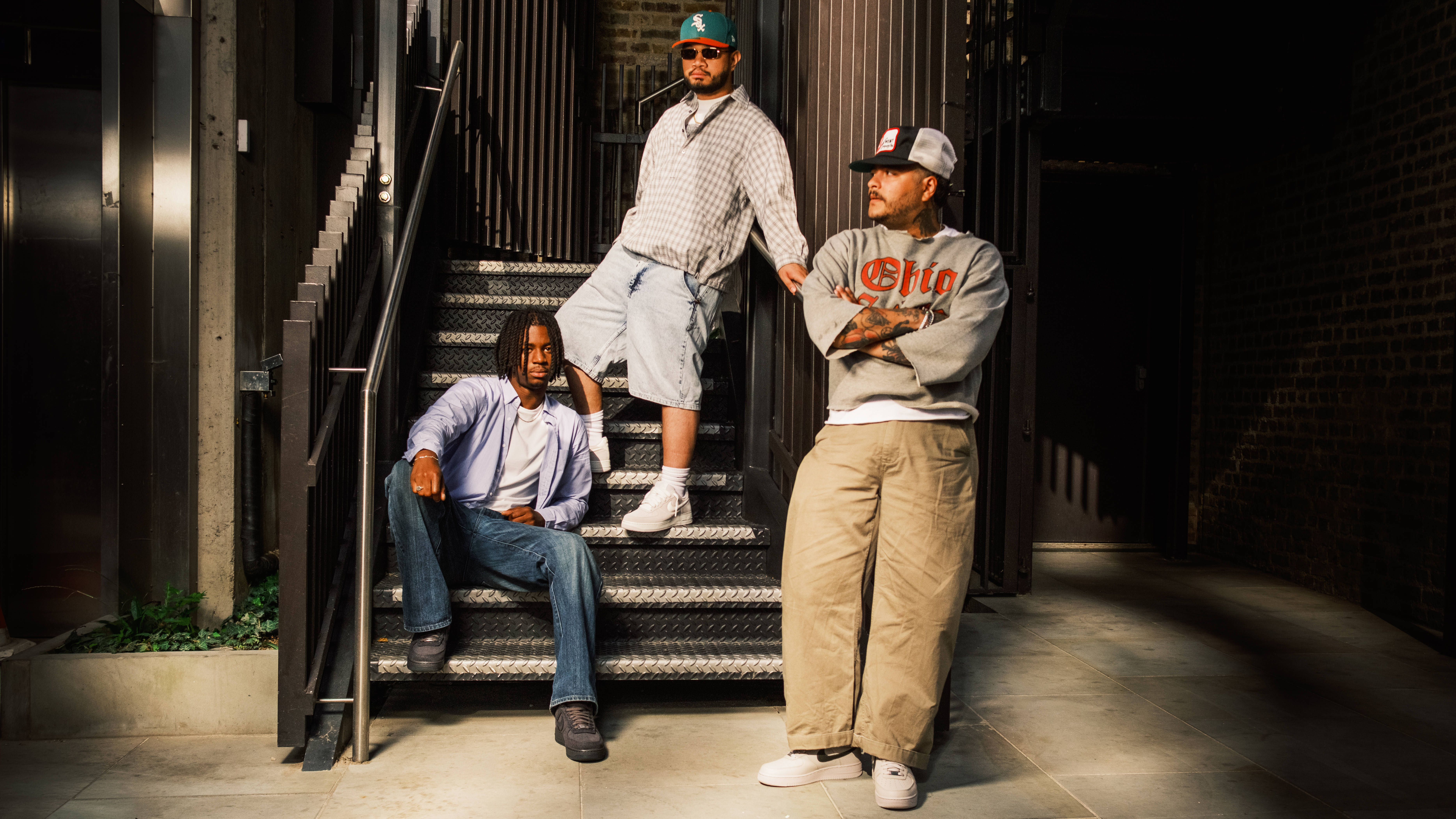 3 guys on staircase styled editorial smart streetwear and americana vintage outfits for the nike air force 1