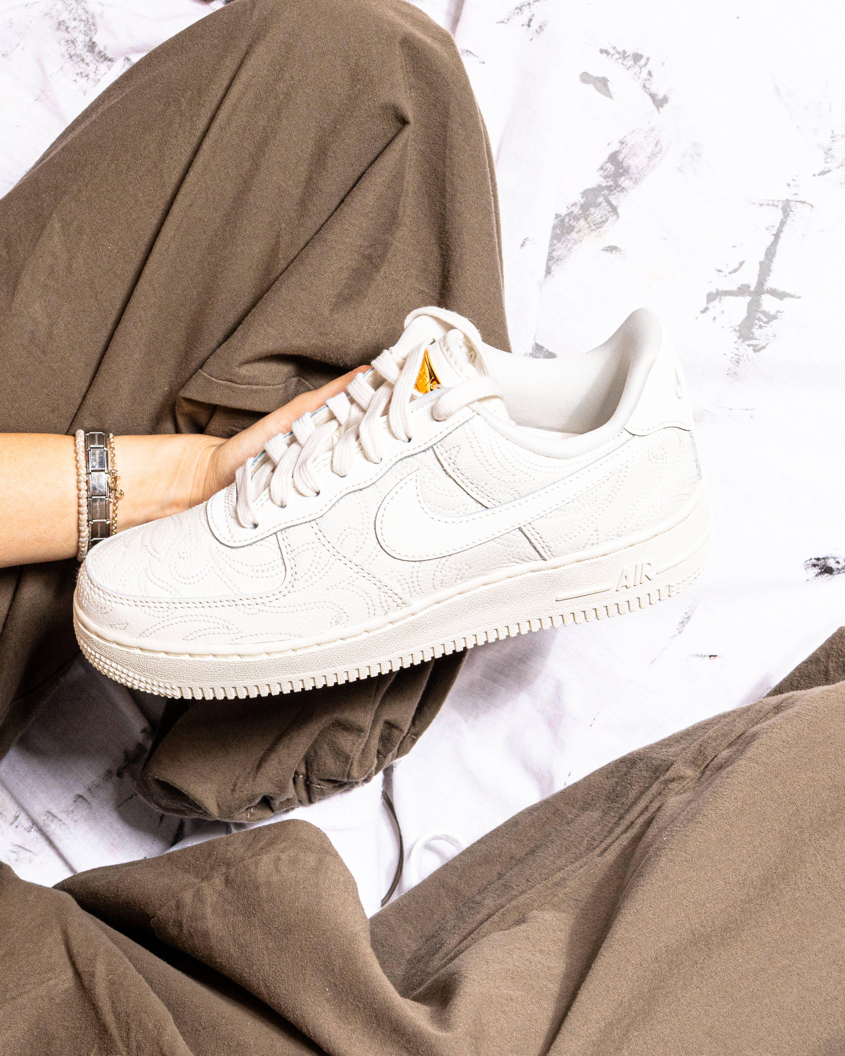 air force 1 pink and brown on studio floor cover