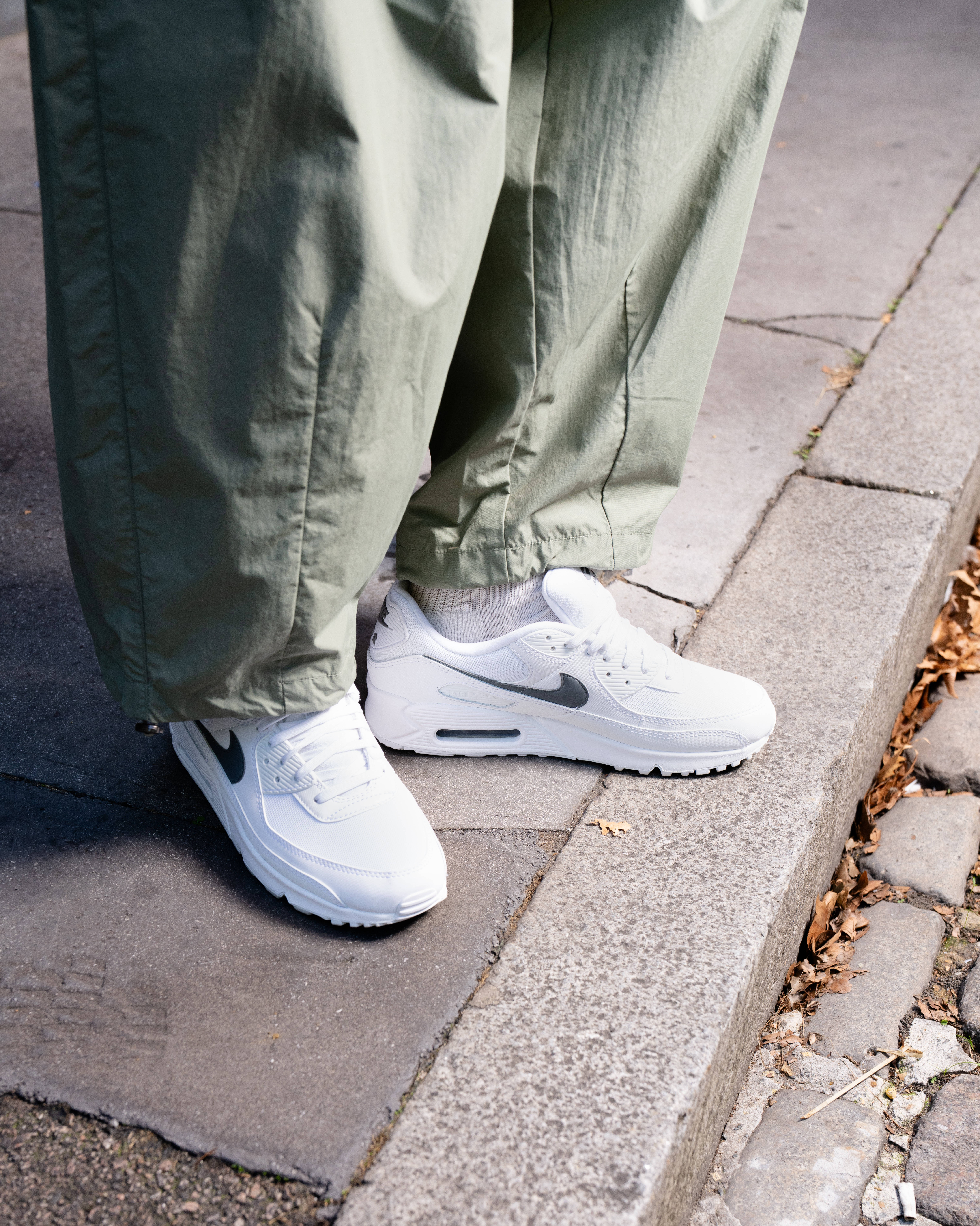 white air max 90 with black swoosh with olive cargo trousers styling