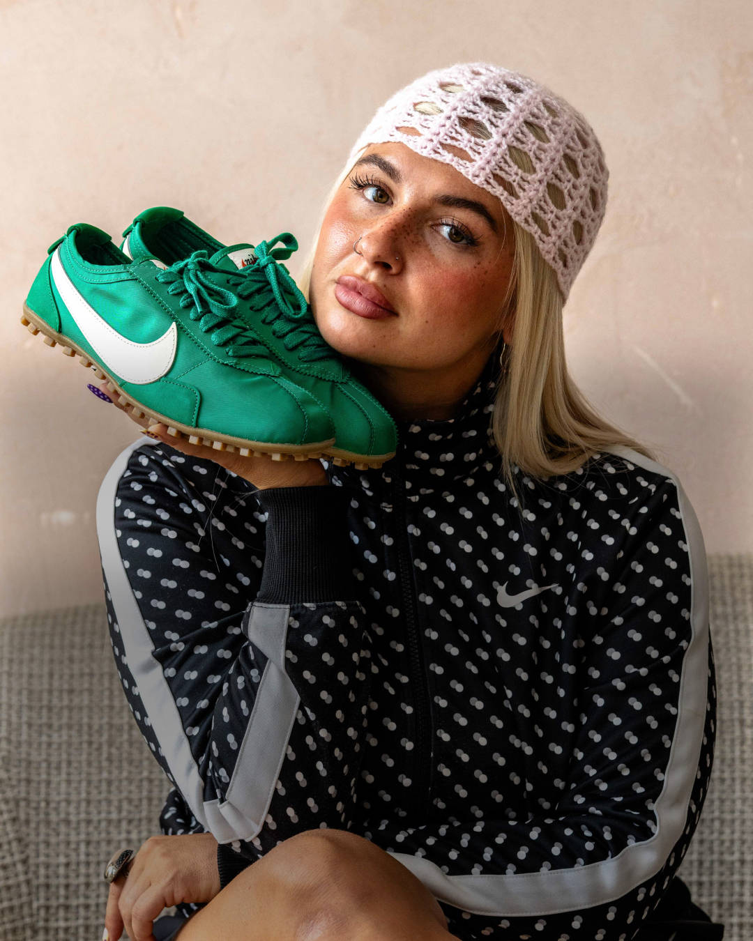 nike moon shoe green white held up to face editorial