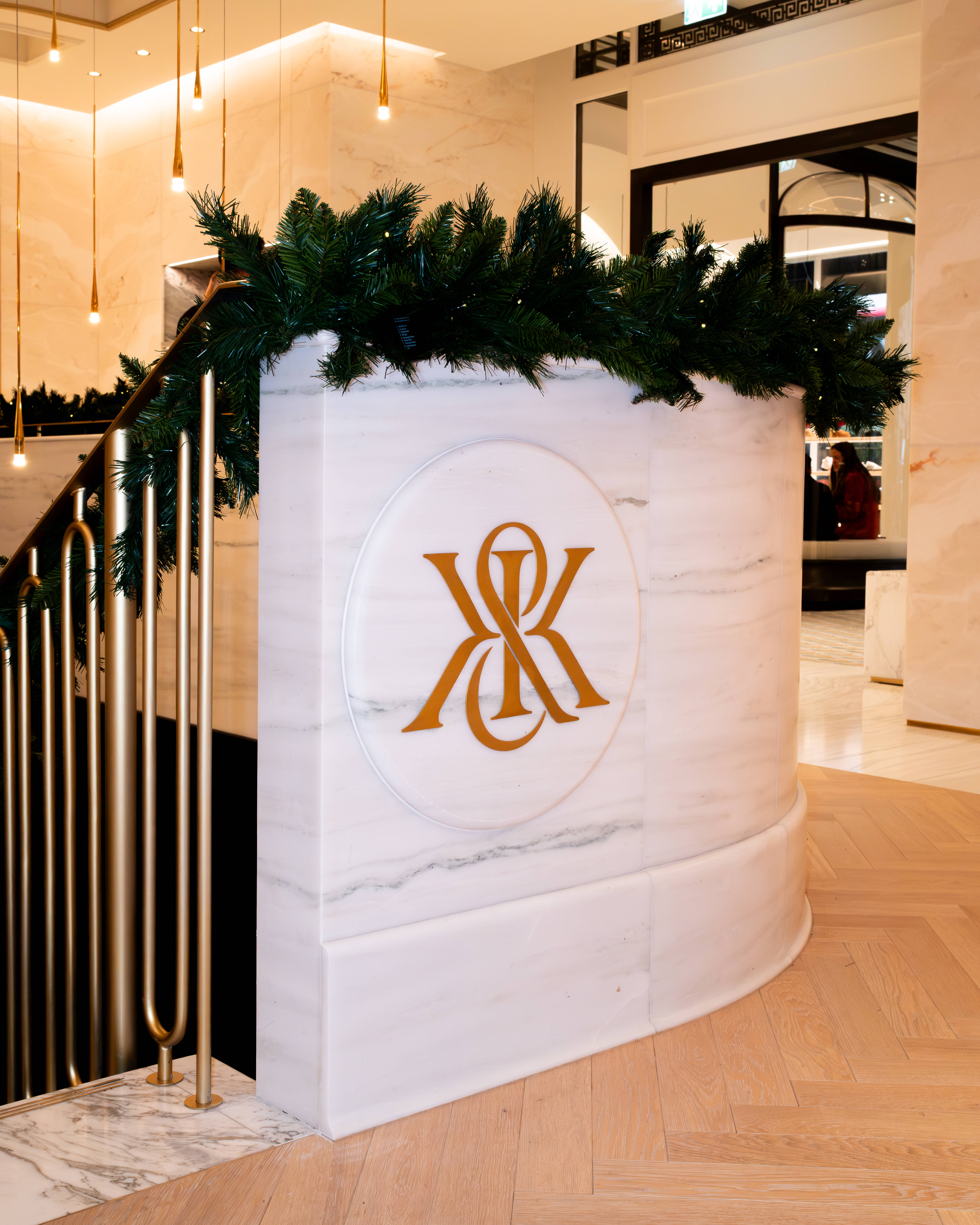 Kith London Store interior gold Kith logo on marble stair bannister second floor 