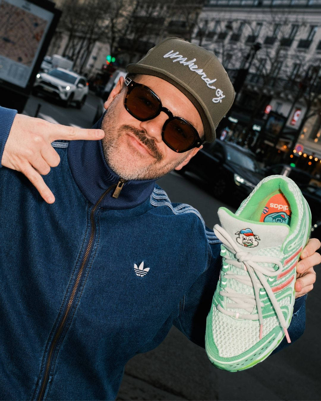 Unheardof founder holding adidas Adistar Cushion 5 Piggy 2.0 streetstyle photo in paris