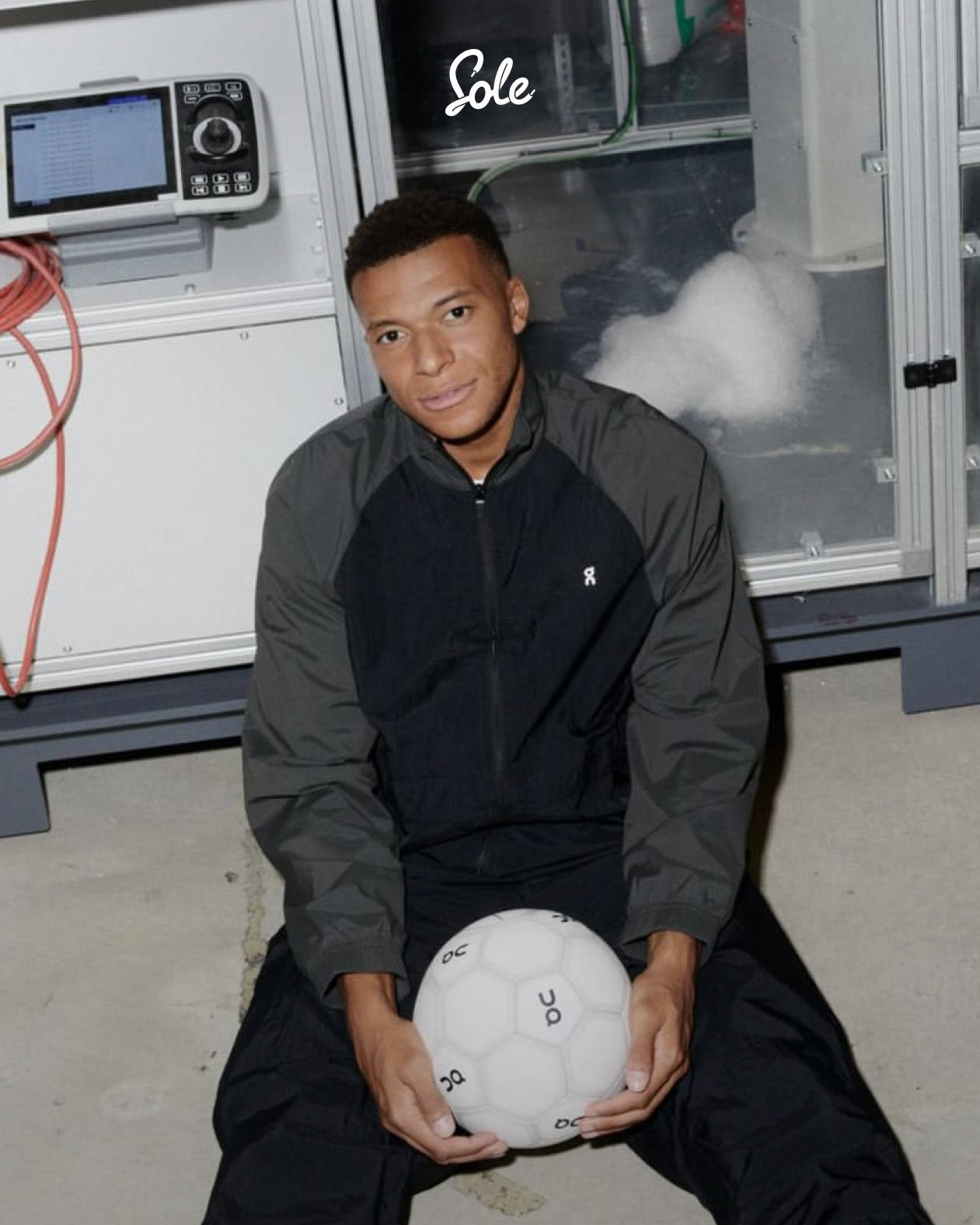 Mbappe in On gear holding football