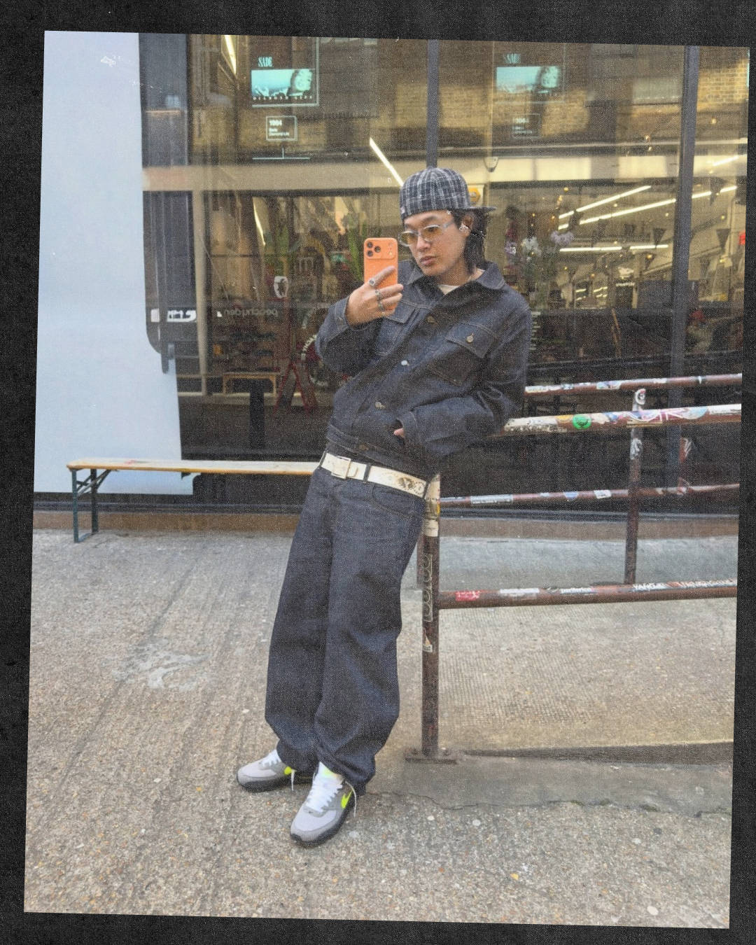 soho london street kid matching raw denim set leaning pose wearing the nike air max 90 neon