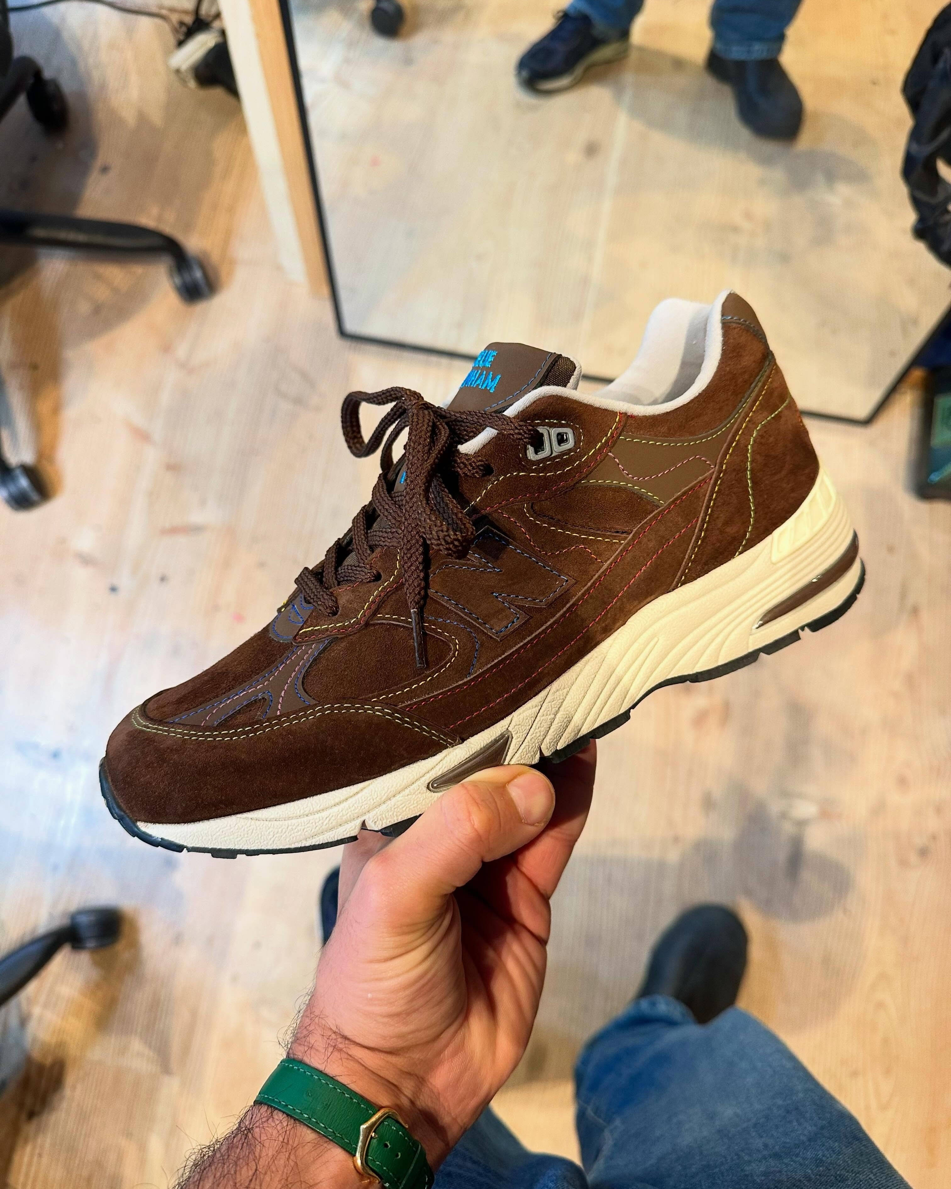 in-hand shot of the bleue burnham new balance 991 brown