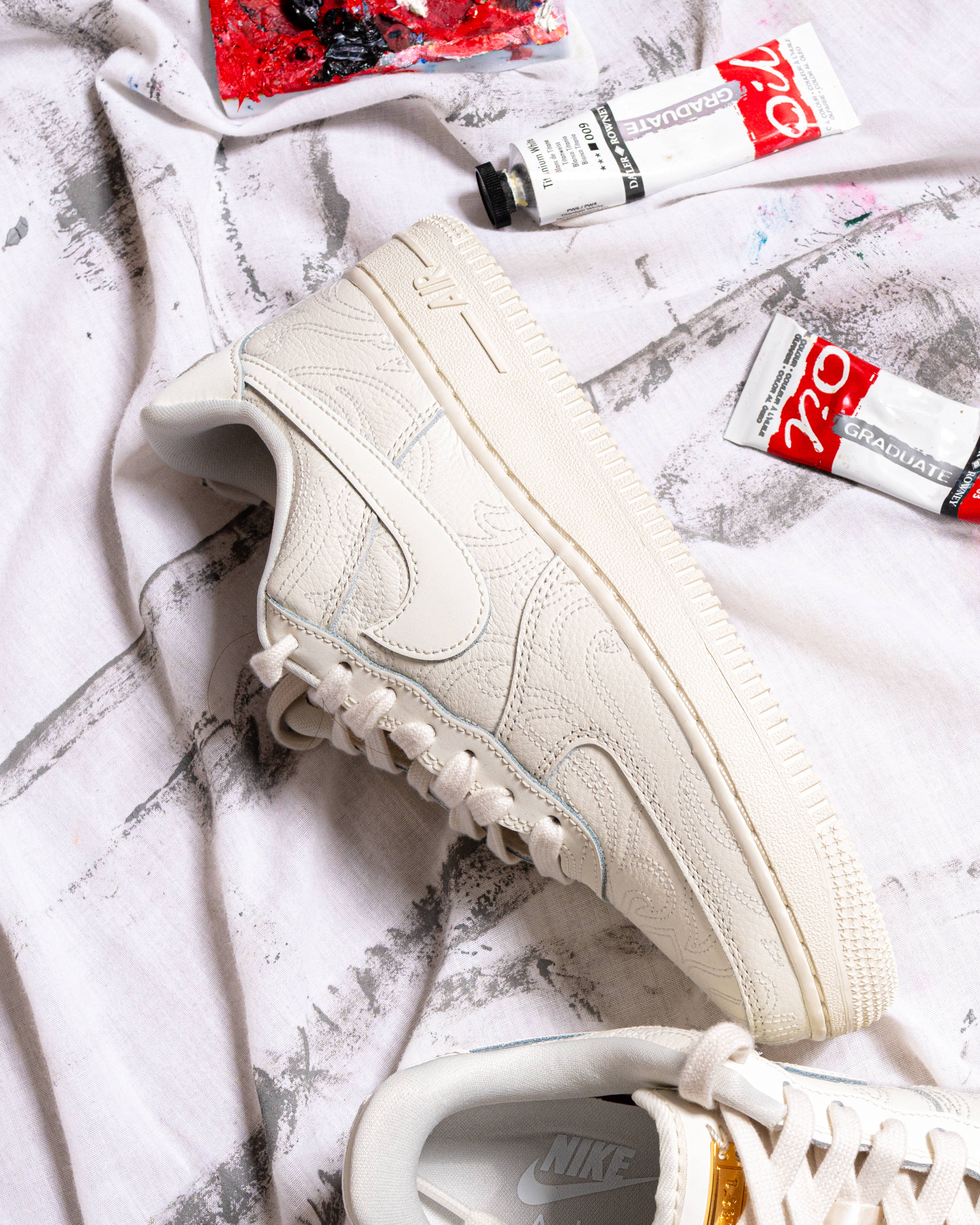 air force 1 in hand with custom studio backdrop