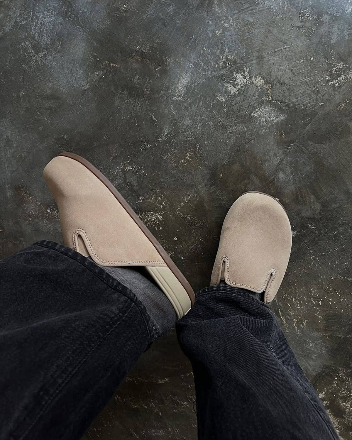 top down shot of vans harbor mule slip-on beige colourway on stone flooring